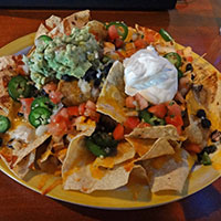 Plate of nachos with whipped cream